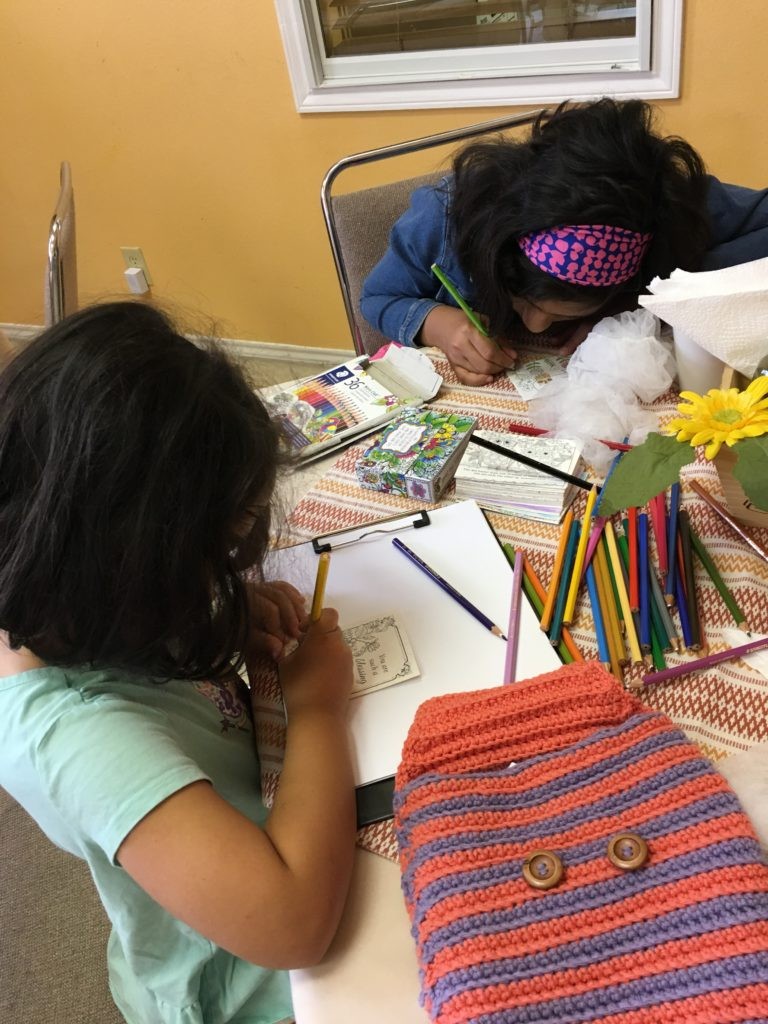 Girls writing letters for Women's prison ministry